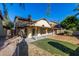 Expansive backyard featuring artificial turf, patio, perfect for outdoor entertaining, and a charming single-Gathering house at 1610 N Apache Dr, Chandler, AZ 85224