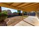 The backyard features a covered patio, and some grass at 1610 N Apache Dr, Chandler, AZ 85224
