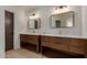 Elegant bathroom features dual vanities with modern fixtures and ample storage space beneath at 1610 N Apache Dr, Chandler, AZ 85224