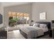 Serene bedroom with a backyard view, soft lighting, and modern furnishings for a relaxing retreat at 1610 N Apache Dr, Chandler, AZ 85224
