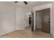 Bedroom with light wood flooring showcases a walk-in closet and adjacent rooms at 1610 N Apache Dr, Chandler, AZ 85224