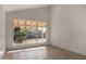 The bedroom offers natural light from the backyard view, wood floors, and neutral colors at 1610 N Apache Dr, Chandler, AZ 85224