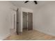 Bedroom with light wood flooring, showcasing a walk-in closet and adjacent rooms at 1610 N Apache Dr, Chandler, AZ 85224