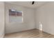 Bright bedroom features wood flooring and a window offering natural light and neighborhood views at 1610 N Apache Dr, Chandler, AZ 85224