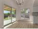 The dining area showcases wood floors, sliding door access to the backyard, and updated light fixture at 1610 N Apache Dr, Chandler, AZ 85224