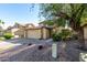 Charming two-story home with a tile roof, two car garage and well-maintained landscaping at 1610 N Apache Dr, Chandler, AZ 85224