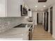 Updated kitchen with stainless steel appliances, backsplash, and bright countertops at 1610 N Apache Dr, Chandler, AZ 85224