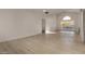 Bright living room with wood floors, neutral colors, and a window showcasing a fenced yard at 1610 N Apache Dr, Chandler, AZ 85224