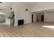 Open floor plan showcasing the fireplace, wood floors, and access to the kitchen at 1610 N Apache Dr, Chandler, AZ 85224