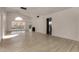 Open floor plan showcases wood floors, access to the kitchen, and fenced backyard at 1610 N Apache Dr, Chandler, AZ 85224