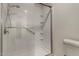 Modern walk-in shower with sleek fixtures, a convenient grab bar, and built-in shelving at 1610 N Apache Dr, Chandler, AZ 85224