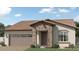 Charming single-story home featuring a desert landscape, a two-car garage and a stone entryway for added curb appeal at 17382 W Artemisa Ave, Surprise, AZ 85387