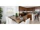 Eat-in kitchen with dark wood cabinets, granite countertops, and stainless steel appliances at 17382 W Artemisa Ave, Surprise, AZ 85387