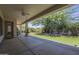 Covered outdoor porch with ceiling fan overlooks artificial grass and a large, mature tree at 17770 N 66Th Ln, Glendale, AZ 85308