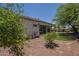 Scenic view of a private backyard with artificial grass, desert landscaping and covered patio at 17770 N 66Th Ln, Glendale, AZ 85308