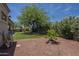 Landscaped backyard with artificial turf, mature shade trees and a gravel area at 17770 N 66Th Ln, Glendale, AZ 85308