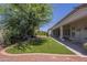 Expansive backyard with green turf, shaded seating area, and well-manicured landscaping at 17770 N 66Th Ln, Glendale, AZ 85308