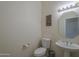 Powder room with pedestal sink, toilet and framed art at 17770 N 66Th Ln, Glendale, AZ 85308