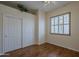 Bedroom with hardwood floors, closet, and window at 17770 N 66Th Ln, Glendale, AZ 85308