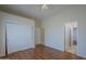 Bright bedroom featuring wood floors, neutral walls and white closet and doors at 17770 N 66Th Ln, Glendale, AZ 85308