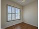 Bedroom with hardwood floors, large window, and a minimalist design at 17770 N 66Th Ln, Glendale, AZ 85308