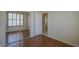 Bedroom with hardwood floors, large closet, and window at 17770 N 66Th Ln, Glendale, AZ 85308