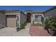 A home's front entrance featuring desert landscaping and a paved walkway at 17770 N 66Th Ln, Glendale, AZ 85308