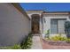 The front of a home featuring a gated entry, potted plants, and desert landscaping at 17770 N 66Th Ln, Glendale, AZ 85308