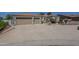 Attractive desert home featuring a large concrete driveway and two-car garage at 17770 N 66Th Ln, Glendale, AZ 85308