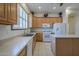 Well-lit kitchen equipped with modern appliances, light wood cabinets, and a functional center island at 17770 N 66Th Ln, Glendale, AZ 85308