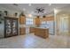 A large kitchen featuring light wood cabinets, a central island, and a tiled floor at 17770 N 66Th Ln, Glendale, AZ 85308