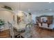 An elegant living room featuring hardwood floors, arched doorways, and a dining set beneath a beautiful chandelier at 17770 N 66Th Ln, Glendale, AZ 85308