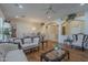 Open-concept living room featuring classic sofas, hardwood floors, archways, and a dining set under a chandelier at 17770 N 66Th Ln, Glendale, AZ 85308