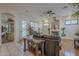 Open-concept living space featuring a view into the kitchen, elegant decor, and lots of natural light at 17770 N 66Th Ln, Glendale, AZ 85308