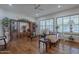A comfortable living room with hardwood floors, a built-in display case, and elegant sofas near shuttered windows at 17770 N 66Th Ln, Glendale, AZ 85308