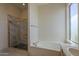 Spacious main bathroom featuring a tub, a separate shower, and dual sinks at 17770 N 66Th Ln, Glendale, AZ 85308