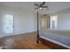 Spacious main bedroom with a ceiling fan, wood floors and patio access at 17770 N 66Th Ln, Glendale, AZ 85308