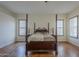 The spacious main bedroom features hard wood floors, a ceiling fan, and natural light at 17770 N 66Th Ln, Glendale, AZ 85308