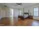 Spacious main bedroom with ensuite access and beautiful wood floors at 17770 N 66Th Ln, Glendale, AZ 85308