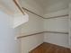 Spacious walk-in closet with wood shelving and hardwood floors providing ample storage at 17770 N 66Th Ln, Glendale, AZ 85308