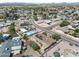 Aerial neighborhood view with mature trees, desert landscaping, pools, and houses equipped with solar panels at 18212 N 43Rd Pl, Phoenix, AZ 85032