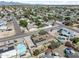 A high-angle aerial scene, showcasing homes with pools and solar panels in a mature neighborhood at 18212 N 43Rd Pl, Phoenix, AZ 85032
