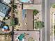 Overhead shot of property with solar panels, backyard pool, desert landscaping and nearby houses at 18212 N 43Rd Pl, Phoenix, AZ 85032