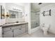 Bathroom featuring a large mirror, modern vanity, tiled shower, and toilet at 18212 N 43Rd Pl, Phoenix, AZ 85032