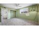 Bedroom featuring green walls, a carpeted floor, a window, a closet, and a ceiling fan at 18212 N 43Rd Pl, Phoenix, AZ 85032