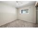 Neutral bedroom offers a sunlit window and neutral carpet and paint, creating a peaceful ambiance at 18212 N 43Rd Pl, Phoenix, AZ 85032