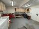 Well-lit garage with laundry area and work bench with overhead cabinets at 18212 N 43Rd Pl, Phoenix, AZ 85032