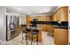Well-appointed kitchen with a center island, granite countertops, and stainless-steel refrigerator at 18212 N 43Rd Pl, Phoenix, AZ 85032