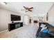 Open-concept living room featuring a modern TV and seamless flow into the kitchen area at 18212 N 43Rd Pl, Phoenix, AZ 85032
