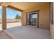 Covered back patio leading to the large fenced backyard with desert landscaping at 18333 N Presley Ln, Maricopa, AZ 85138